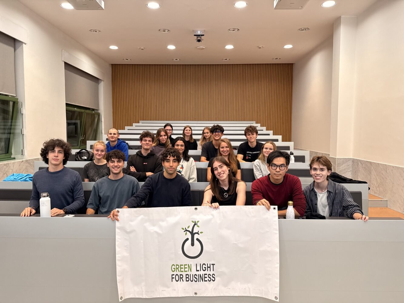 Members of Green Light for Business in a Bocconi lecture hall with the association banner, autumn 2024