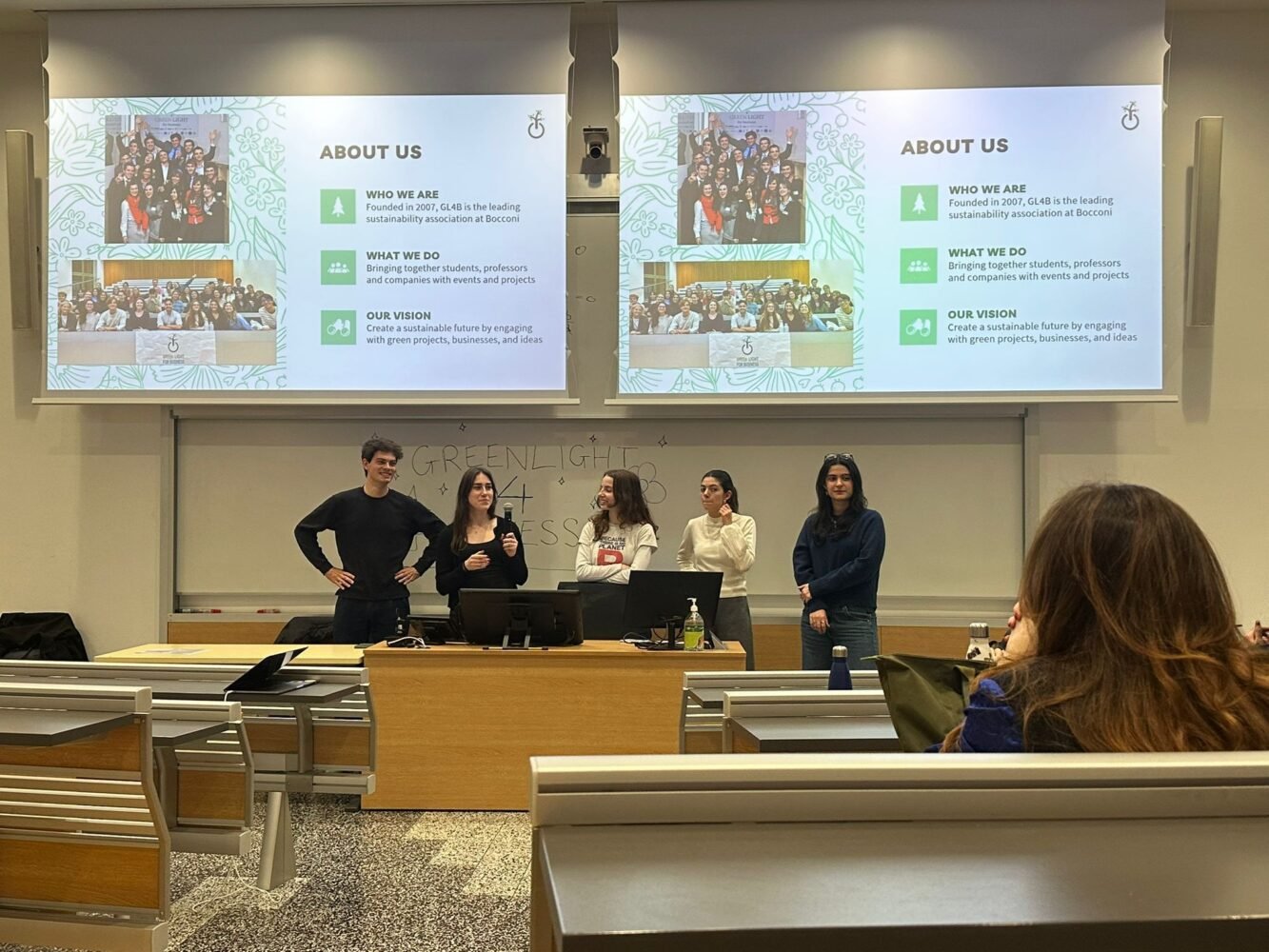 The board presenting the association in a Bocconi lecture hall